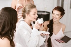 three beautiful women drinking tea and make-up session