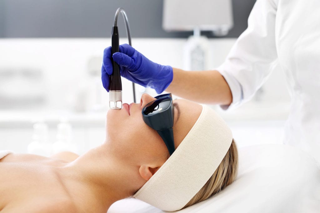 woman in a beauty salon during a laser genesis treatment.