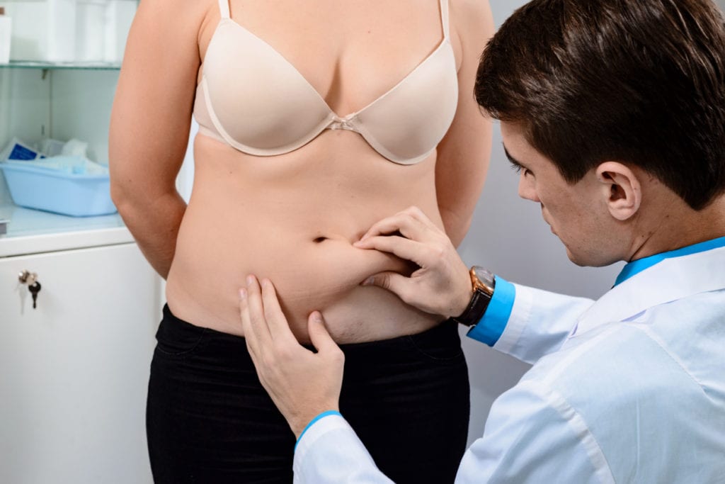 Examination of the patient before the liposuction procedure. - CoolSculpting